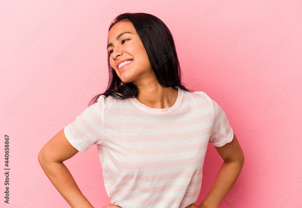 Young Venezuelan woman isolated on pink background confident keeping hands on hips. Young Venezuelan woman isolated on pink background confident keeping hands on hips.