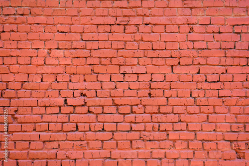 The brick wall is painted red. Focusing in the center of the frame.