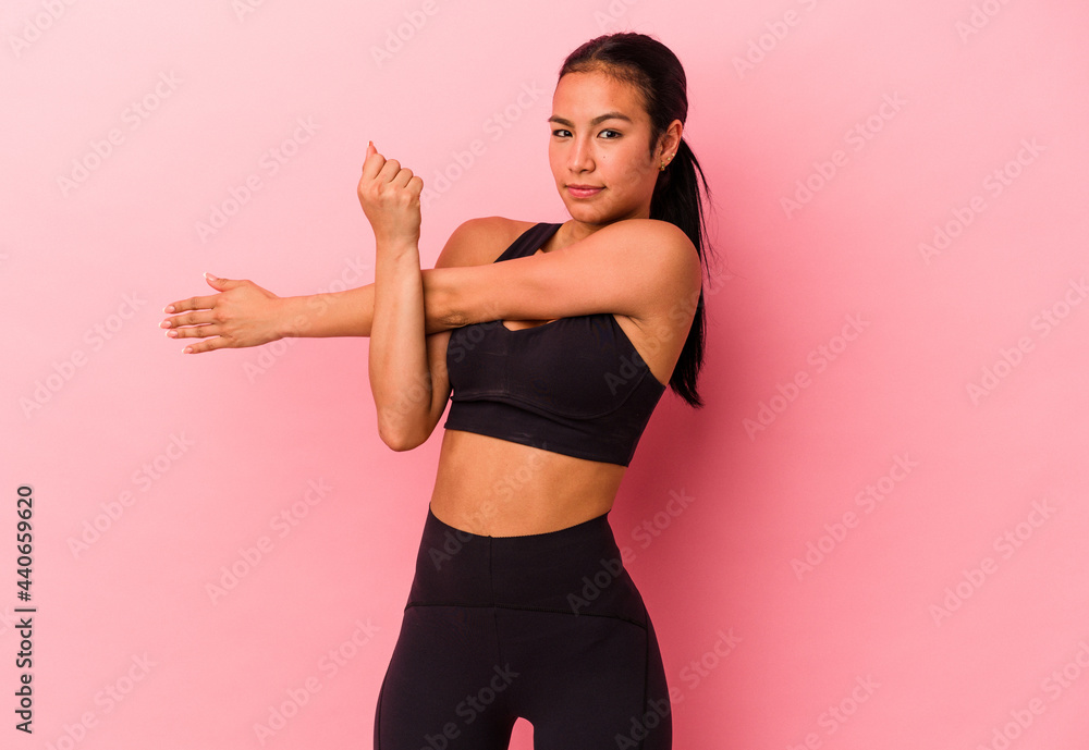 Young sport venezuelan woman isolated on pink background Young sport venezuelan woman isolated on pink background