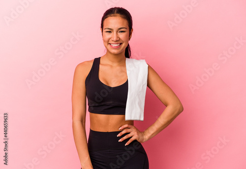 Young sport venezuelan woman isolated on pink background