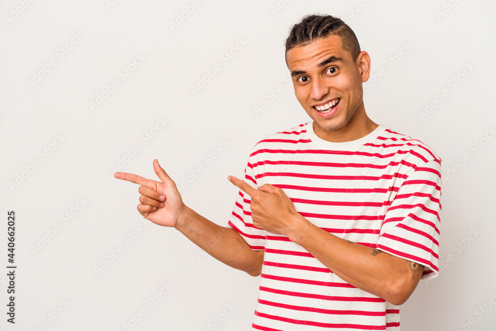Young venezuelan man isolated on white background excited pointing with forefingers away. Young venezuelan man isolated on white background excited pointing with forefingers away.