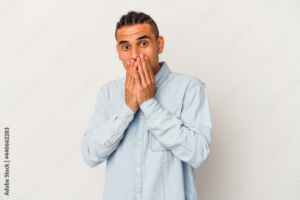 Young venezuelan man isolated on white background shocked covering mouth with hands. Young venezuelan man isolated on white background shocked covering mouth with hands.