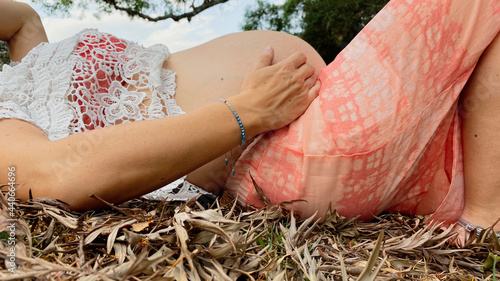 pregnant woman lying on dry leaves. Pregnancy, motherhood, new mother