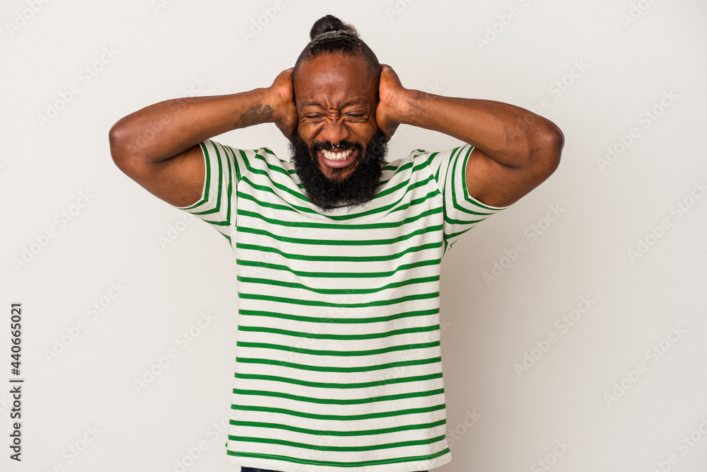 African american man with beard isolated on pink background covering ears with hands trying not to hear too loud sound. African american man with beard isolated on pink background covering ears with hands trying not to hear too loud sound.