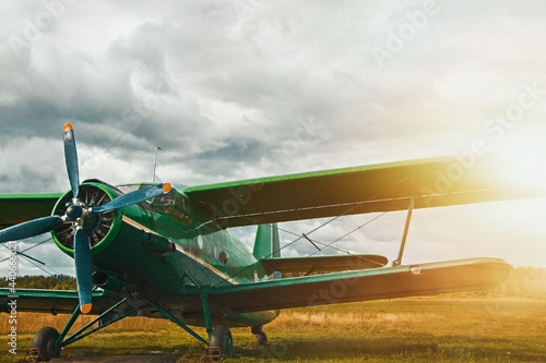 Fototapeta Naklejka Na Ścianę i Meble -  Vintage aircraft preparing for take-off on the background of stormy sky