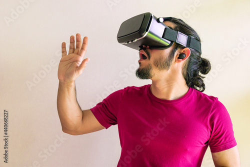 Young latin man using a Virtual Reality Device at home © Angel Gruber