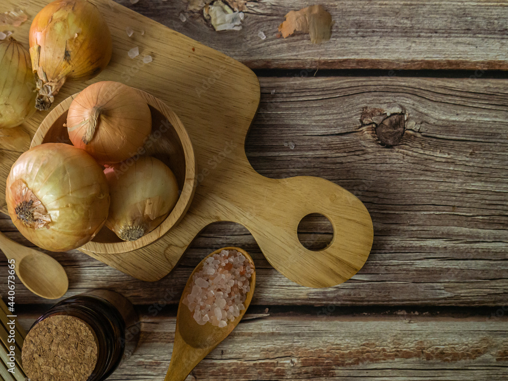 The onions on wood table for food or cooking concept. The onions on wood table for food or cooking concept.