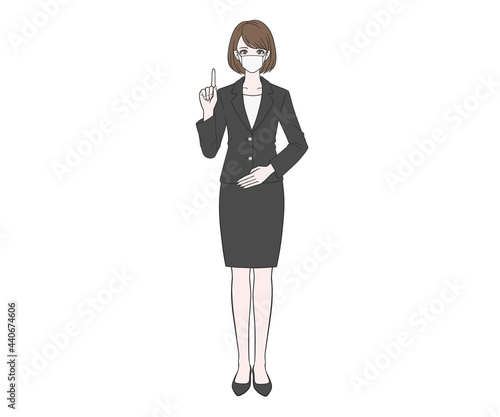 人差し指を立てるマスクをつけたスーツの女性