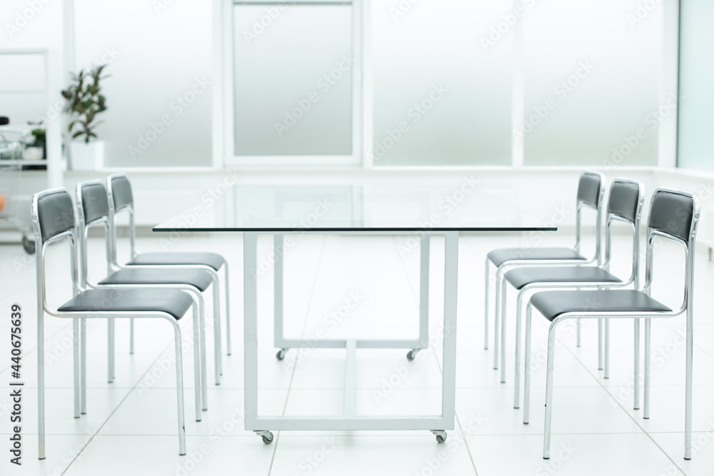 Fototapeta premium Laptop on glass table in spacious office space