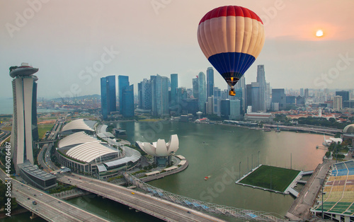 Photography Aerial view of hot air balloon flying over Marina Bay Sands