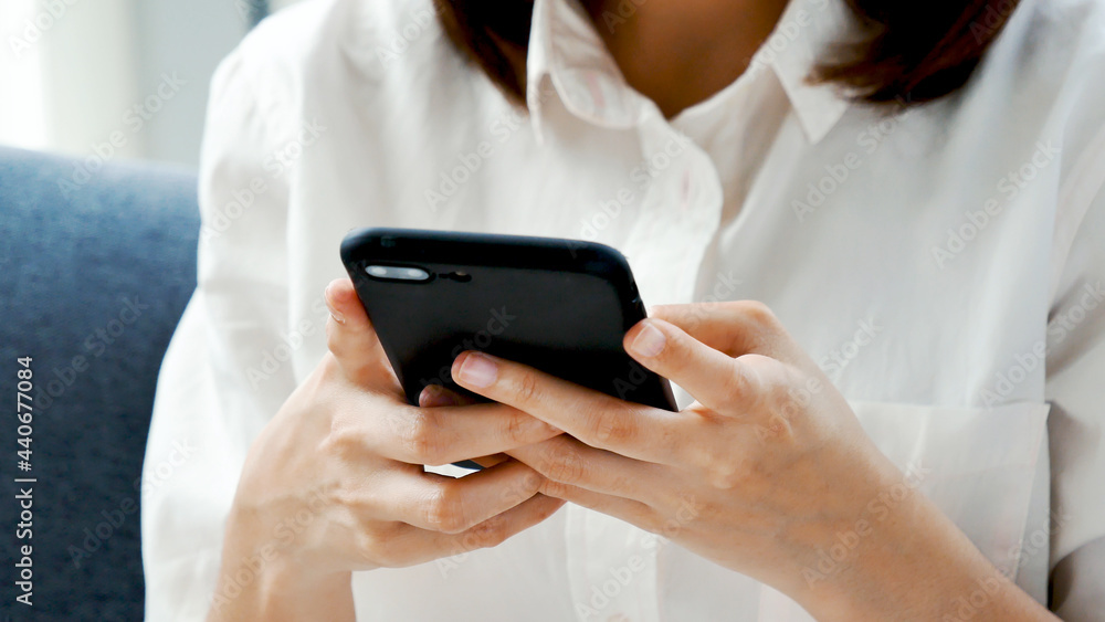 Smiling face asian woman holding smartphone with E-commerce Shopping online website Reading Online Article, Blog, vlog. Young Woman hands holding phone technology lifestyle. Woman using smart phone. Smiling face asian woman holding smartphone with E-commerce Shopping online website Reading Online Article, Blog, vlog. Young Woman hands holding phone technology lifestyle. Woman using smart phone.
