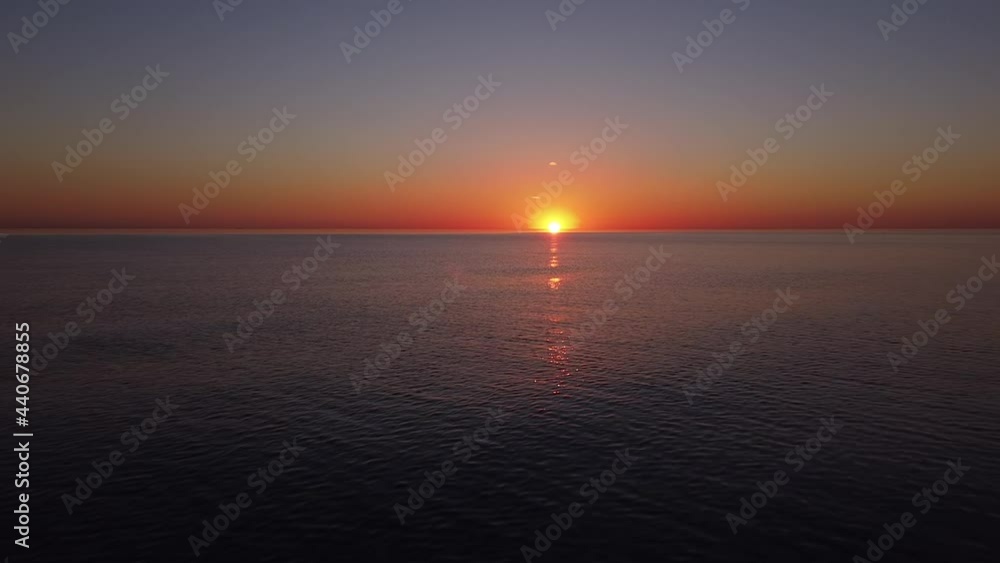 Beautiful aerial vibrant high contrast pink purple sunset over calm Baltic sea near Karosta war port concrete coast fortification ruins at Liepaja, wide angle drone shot moving forward Beautiful aerial vibrant high contrast pink purple sunset over calm Baltic sea near Karosta war port concrete coast fortification ruins at Liepaja, wide angle drone shot moving forward