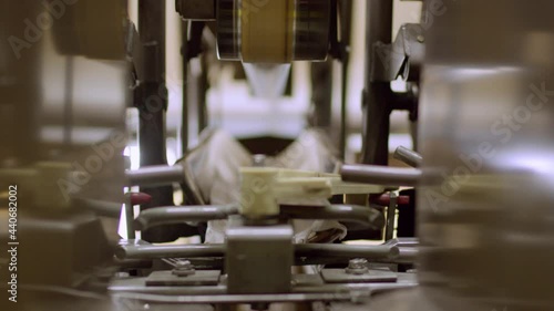 A red bowling ball passes through the pinsetter machine at a bowling alley. photo