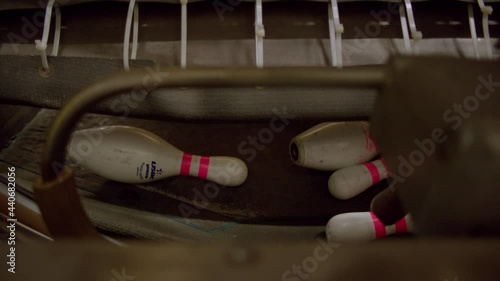 Bowling pins are sifted through a pinsetter machine at a bowling alley. photo