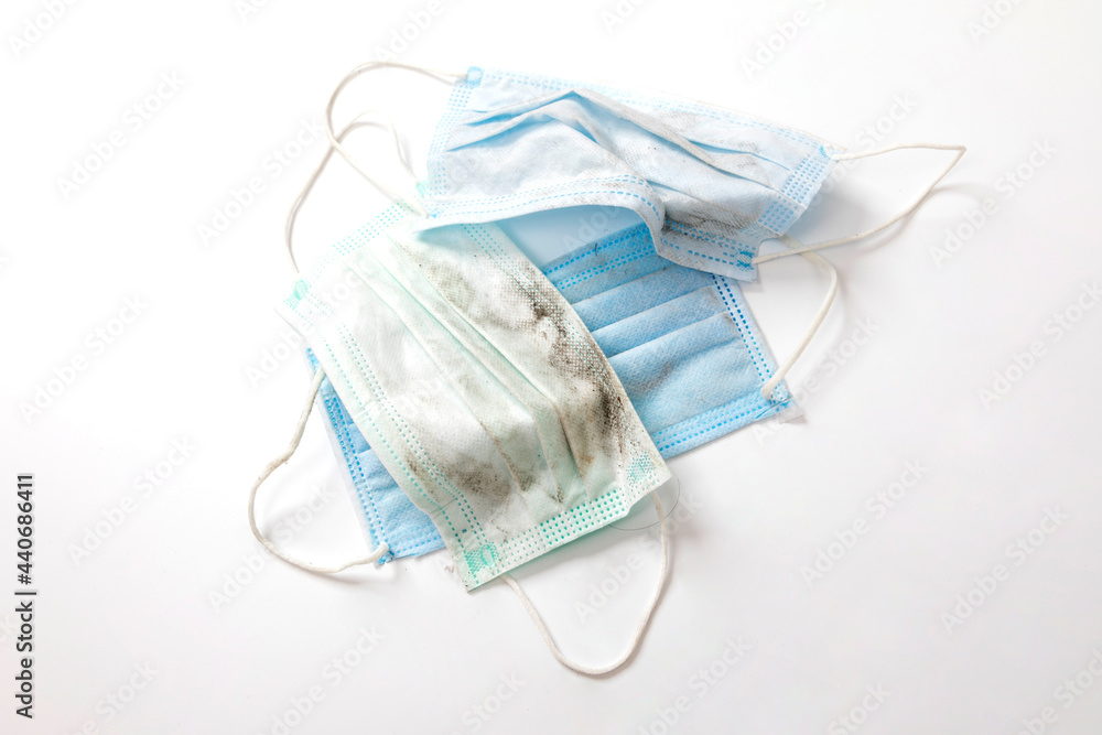 Discarded used facemask on white background. Discarded used facemask on white background.