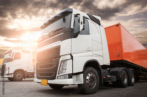 Semi Trailer Trucks The Parking lot at Sunset Sky. Delivery Container Trucks. Cargo Shipping. Lorry. Industry Freight Truck Logistics Cargo Transportation  © Siwakorn1933