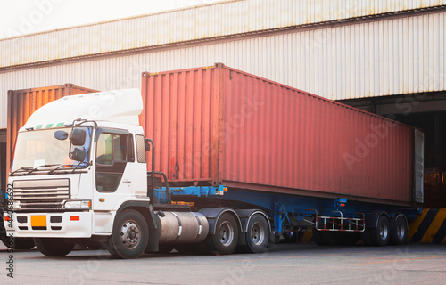 Trailer Truck Loading at Dock Warehouse. Cargo Shipment. Industry Freight Truck Transportation. Shipping Warehouse Logistics.