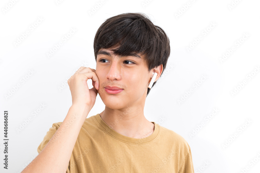 joyful handsome boy teen wearing earpods smiling on white background. joyful handsome boy teen wearing earpods smiling on white background.