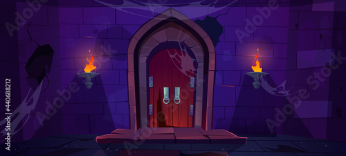 Broken wooden door in medieval castle. Old wood gate in stone wall with flaming torches at night. Vector cartoon illustration of entrance to dungeon, prison or abandoned fortress