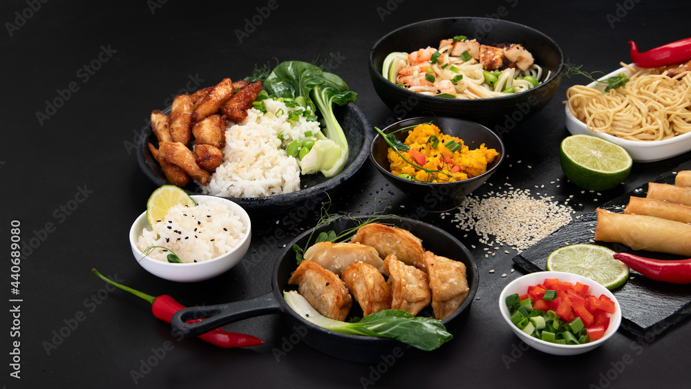 Assorted asian dishes and snacks on black background. Traditional food concept. Assorted asian dishes and snacks on black background. Traditional food concept.