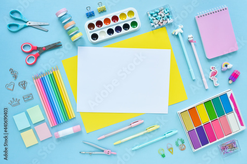 Background of school supplies in pastel colors on a light blue background. Copyspace. Office supplies. Back to school. It was flat.