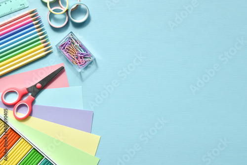 Stationery on a light blue background with space for text. Back to school. Flat lay.