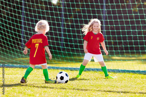 Portugal football fan kids. Children play soccer.
