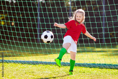 Portugal football fan kids. Children play soccer. © famveldman