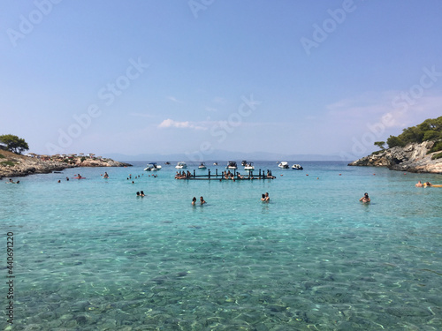 Fototapeta Naklejka Na Ścianę i Meble -  Aponisos beach, a pebble beach in a small cove with sheltered swimming, seen from Aponisos Island in the vicinity of Agistri, Greece. 