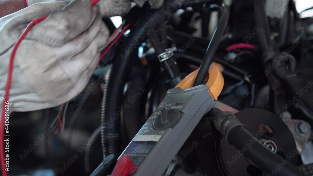 Auto mechanic using measuring equipment tool checking car engine, Repair and maintenance service concepts Auto mechanic using measuring equipment tool checking car engine, Repair and maintenance service concepts