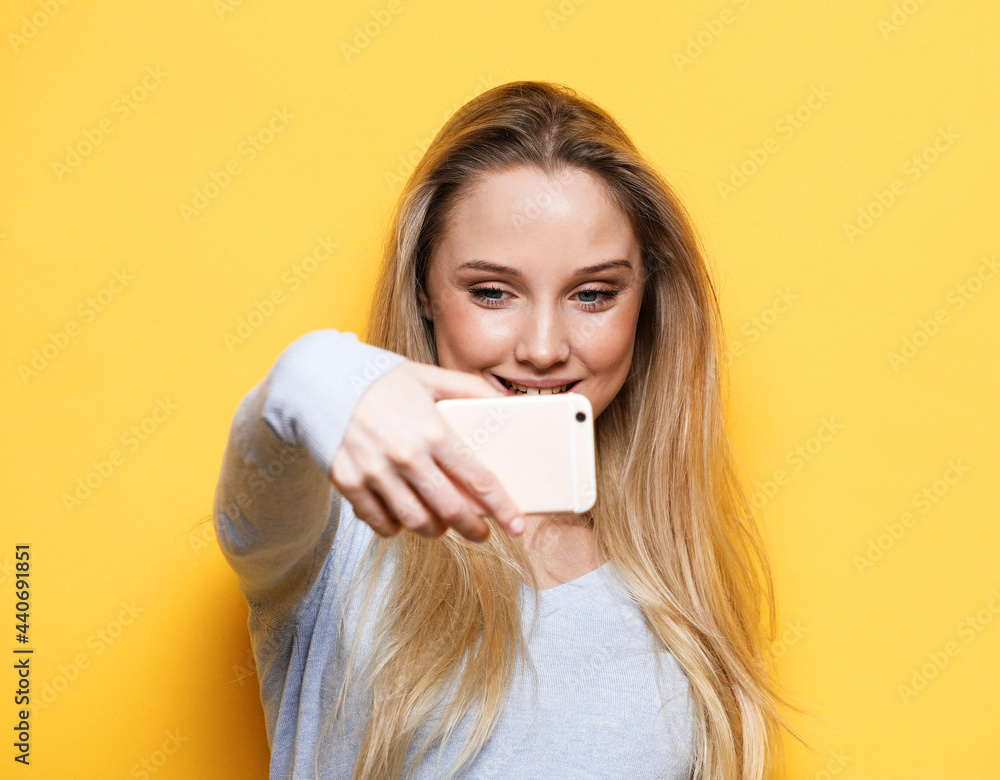 Image of charming optimistic woman wearing casual clothes taking selfie photo Image of charming optimistic woman wearing casual clothes taking selfie photo