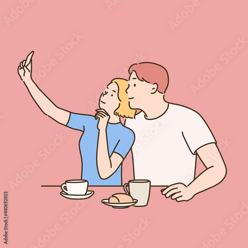 A couple is sitting in a cafe and taking a selfie with their phone. hand drawn style vector design illustrations. 