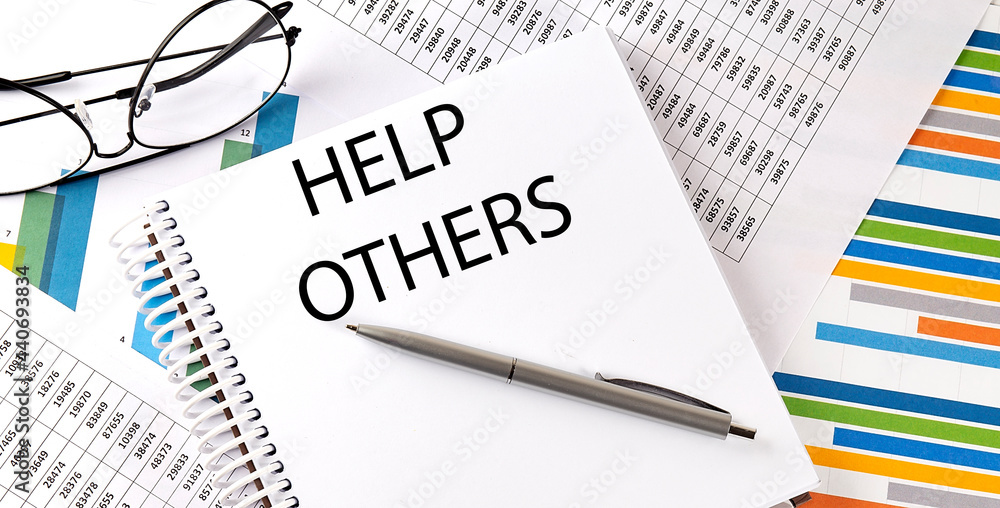 Notebook with text HELP OTHERS . Diagram and white background Notebook with text HELP OTHERS . Diagram and white background