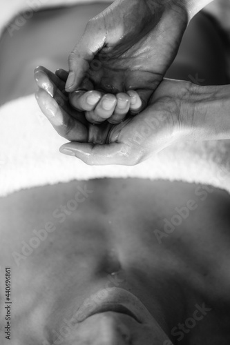 Ayurvedic Aromatherapy Oil Massage. Masseuse Holding Ayurveda Oil for Body Massage