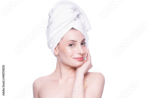 Beautiful attractive blond young woman with clean fresh soft skin applying cream with white background. Beauty care face treatment. Natural studio healthy cosmetic portrait. Cosmetology, beauty, spa