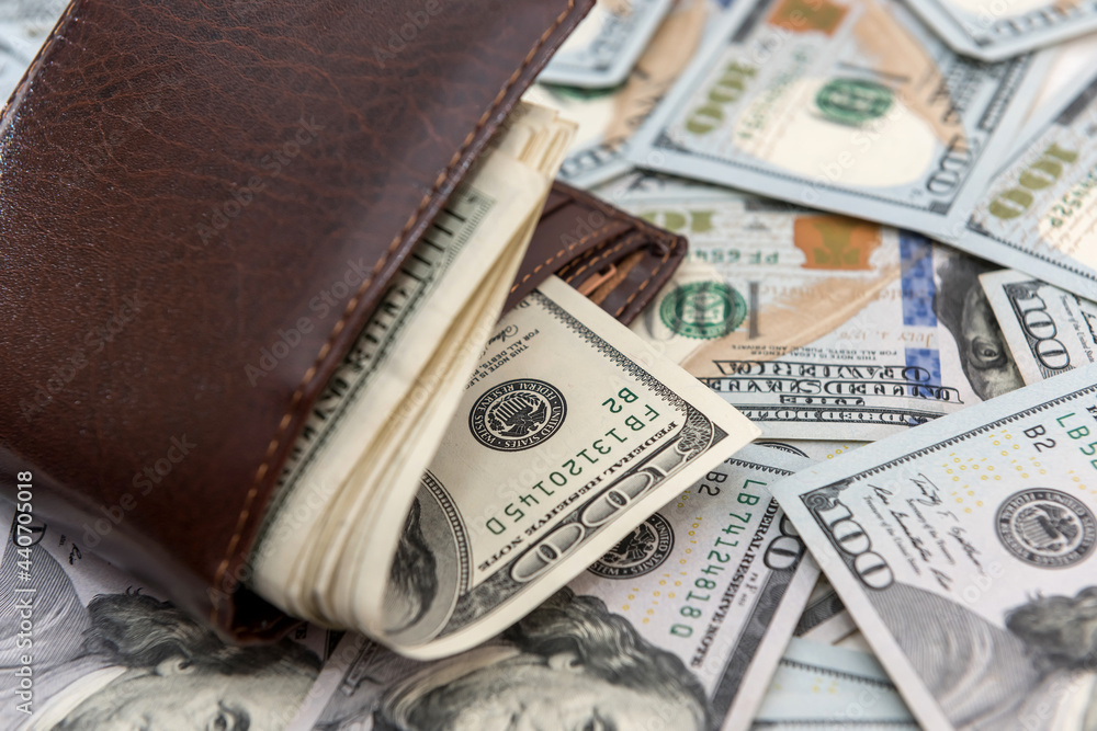 dark leather men's wallet full dollar bills as financial background dark leather men's wallet full dollar bills as financial background