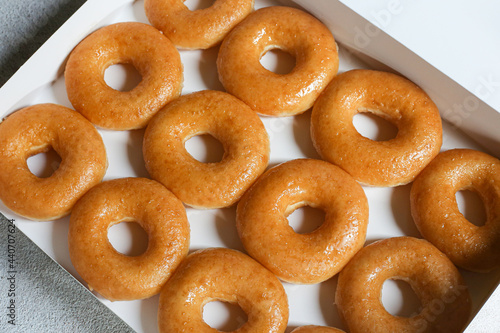 Glazed donuts original Delicious sugar pattern in box white, Selective focus. photo