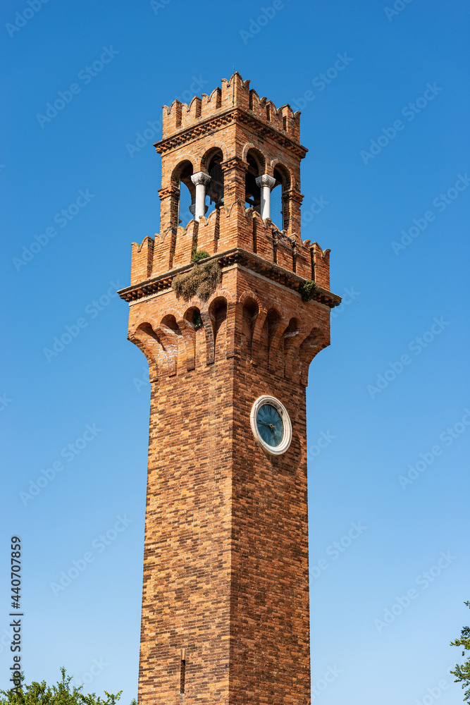 Close-up of the ancient Civic Tower or Clock Tower in Murano island in medieval style. Campo Santo Stefano (Saint Stephen square), Venice, UNESCO world heritage site, Veneto, Italy, Europe.