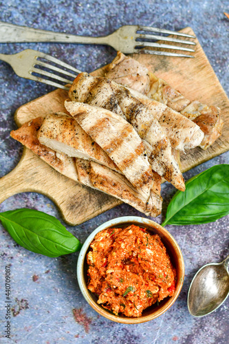  Grilled chicken fillets with  olive oil, chili pepper,   and tomato paste 