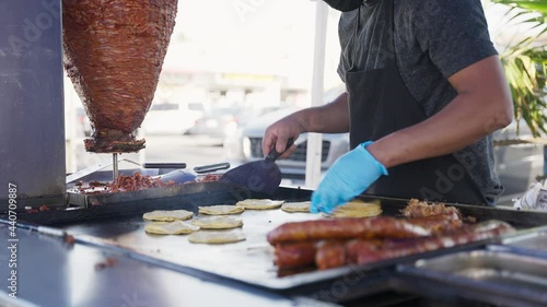 Man preparing some tacos, street food 