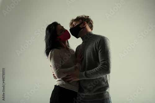 Faces of people in protective masks. Lifestyle COVID-19 home together. Couple mask. 