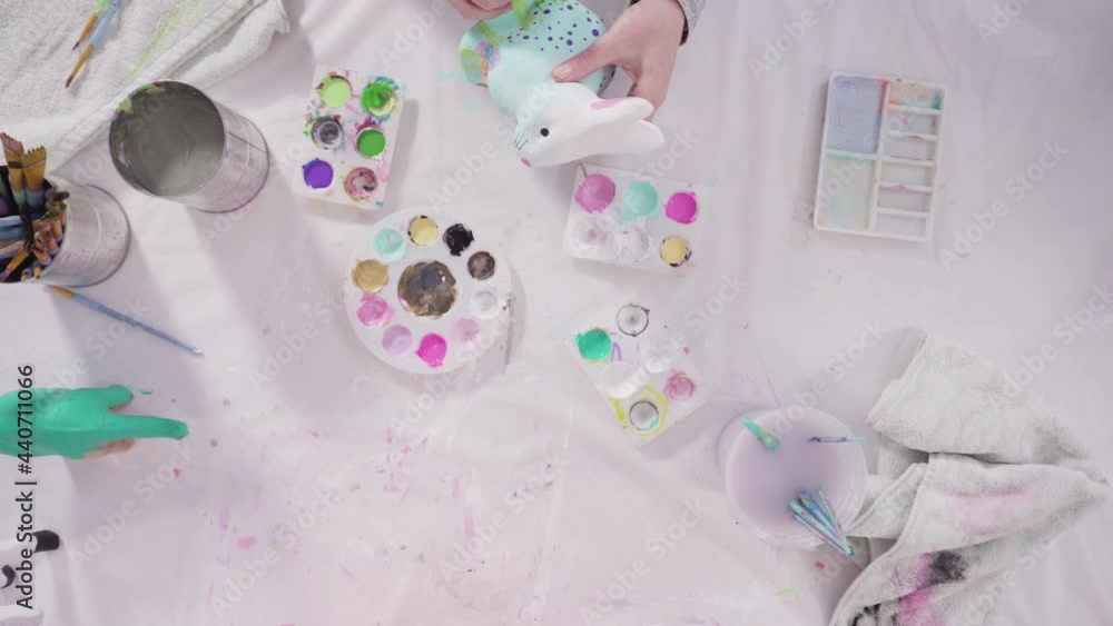 Flat lay. Little girl painting paper mache figurines with acrylic paint for her homeschooling art project. Flat lay. Little girl painting paper mache figurines with acrylic paint for her homeschooling art project.