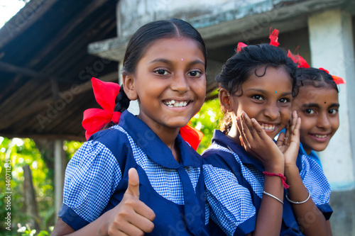 Indian rural school girls sitting at school showing thumbs up photo