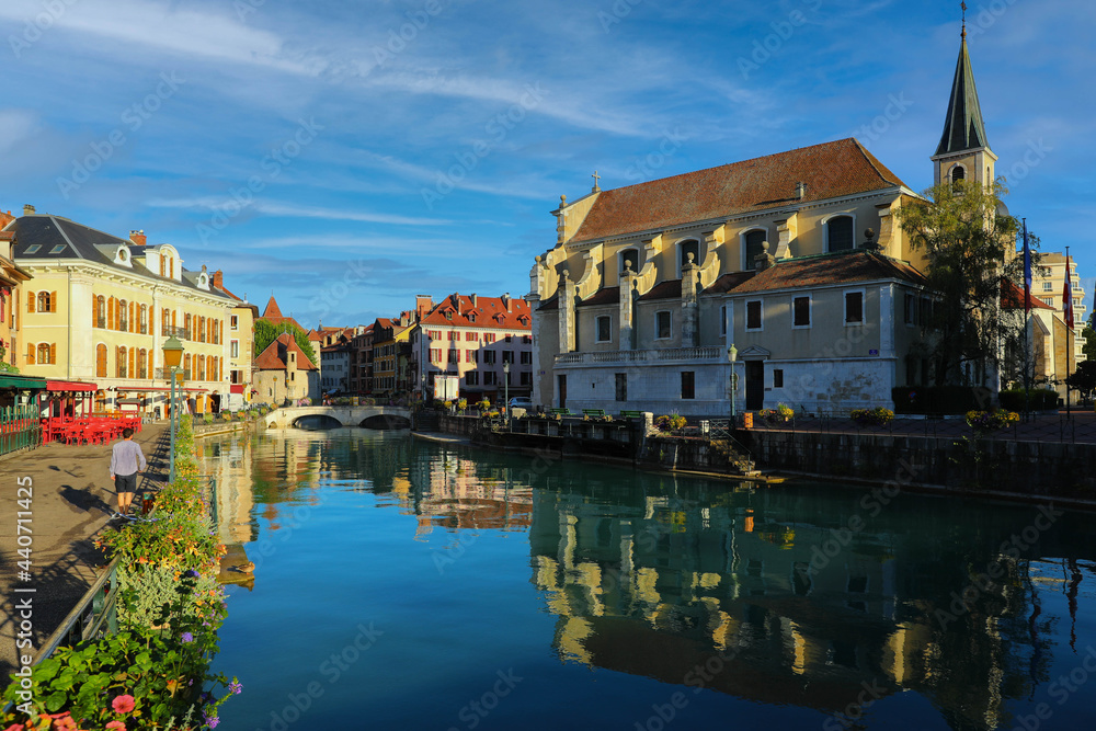 Colourful medieval buildings reflected on water of the canal in Annecy, France