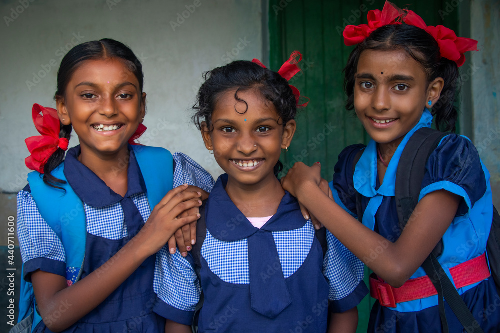 Smiling Three indian Rural School Girl wearing School Uniform Standing