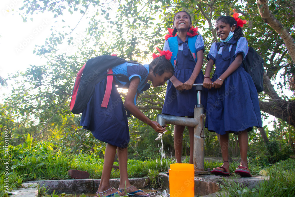 Indian Rural School Girls drinking water from Tubewell at village Stock ...