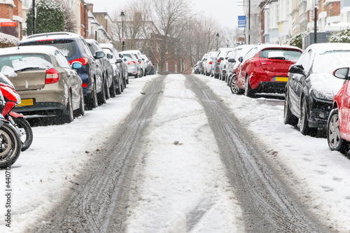 Uphill street covered with snow around West Hampstead area in London, adverse driving conditions.