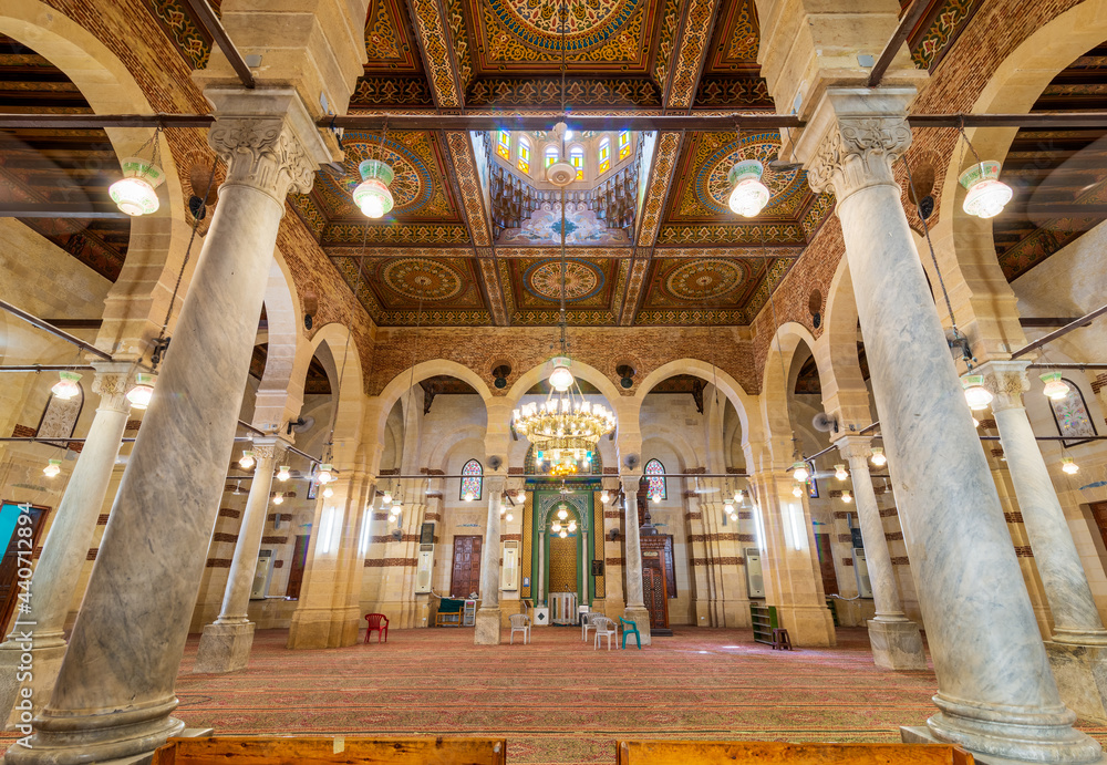 Interior of public historical Mamluk era Imam Al Shafii Mosque suited in Old Cairo, Egypt, with Wooden ceiling decorated with colorful floral patterns and dome