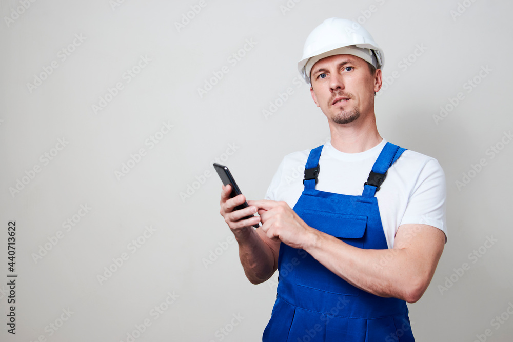 Foreman worker using smartphone on white background Foreman worker using smartphone on white background