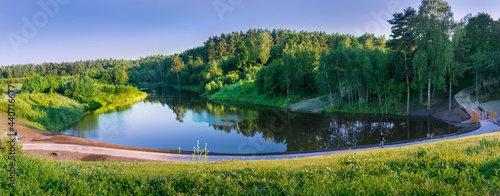 Moscow. June 19, 2021. Summer landscape in Meshchersky park. Nice view of the road along the pond